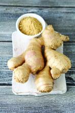 Spicy ginger root and ginger powder on a cutting board